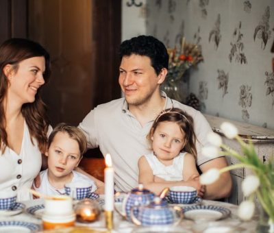 A warm family gathering celebrating a traditional Russian holiday indoors with festive food and decor.